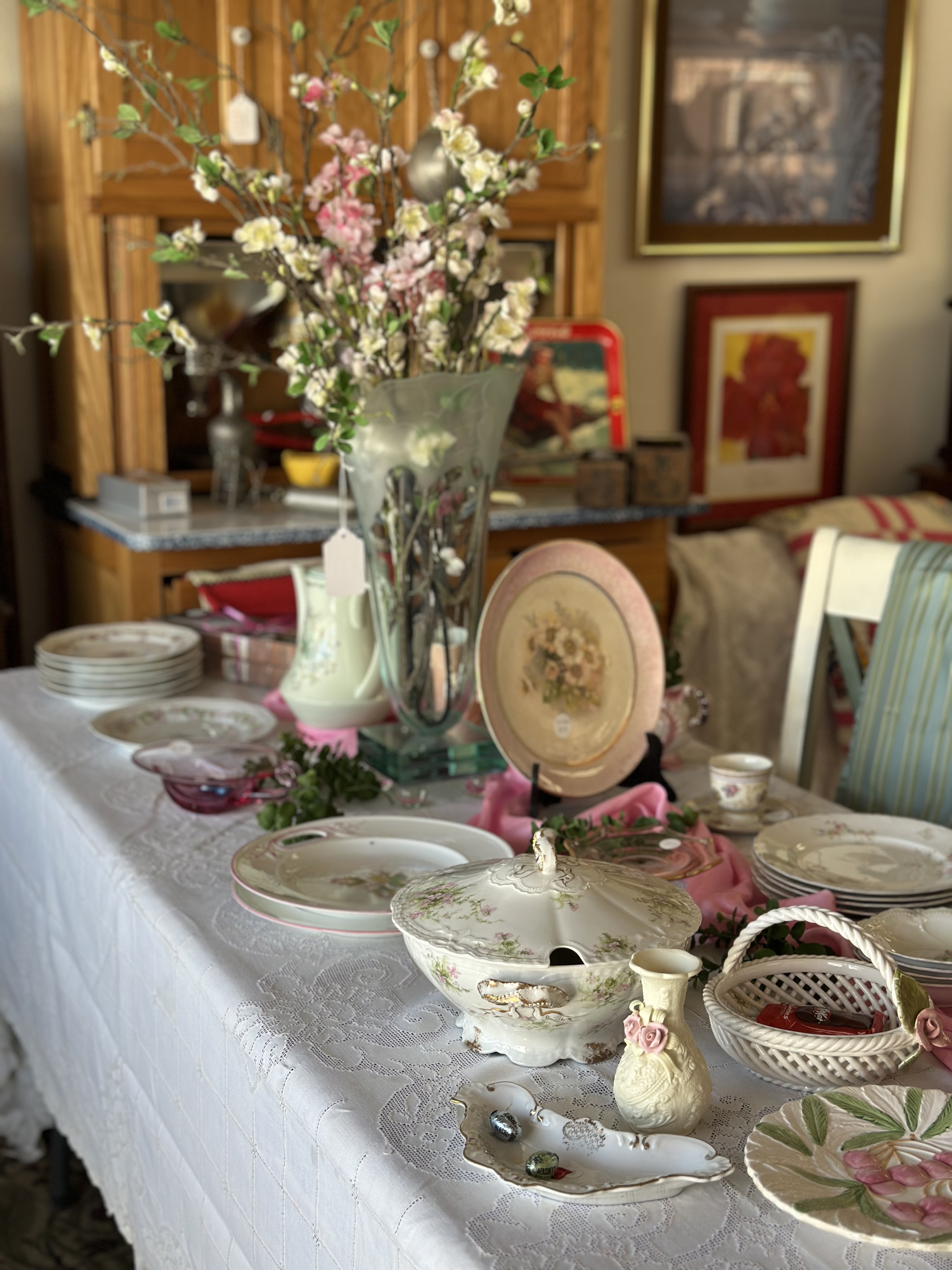 Table set with floral arrangements and vintage dishes